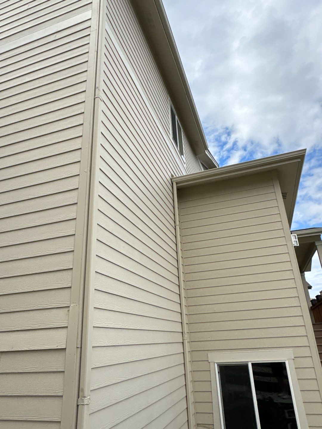Before — faded beige Castle Rock exterior with lap siding and trim