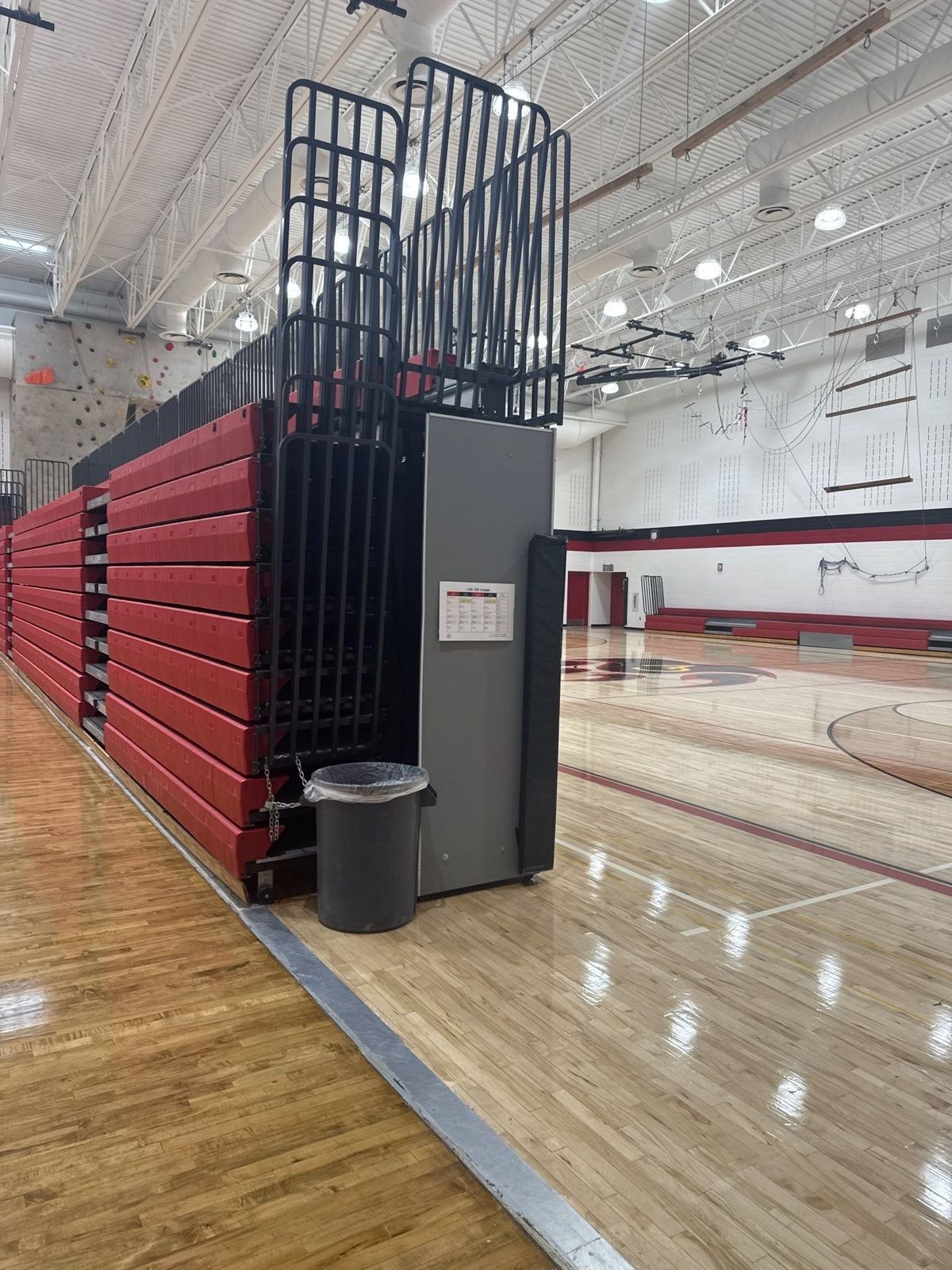 Castle View High School gym repaint showing painted walls and banding behind the retractable bleachers