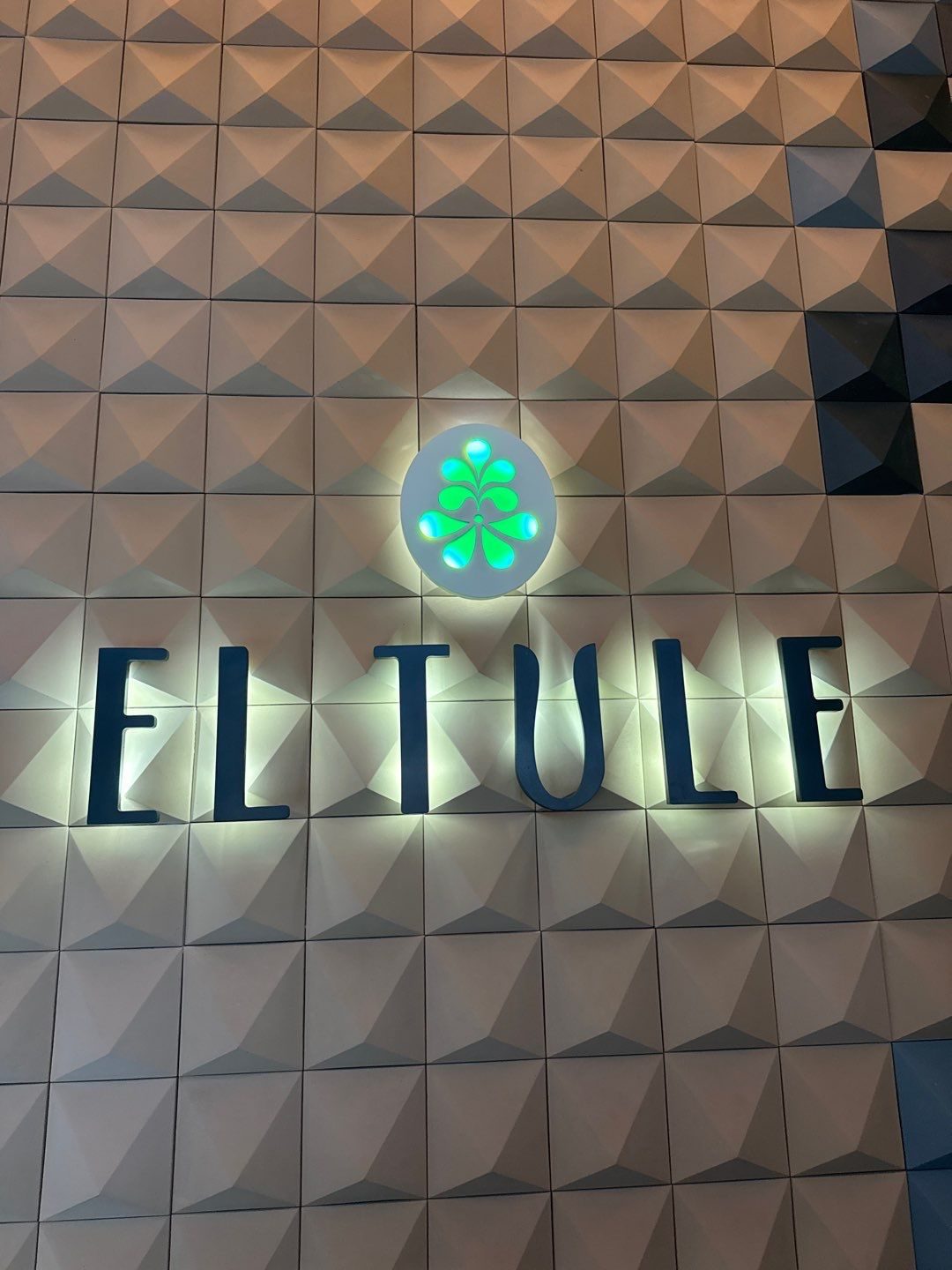 Lit El Tule sign on a 3D tile feature wall at the Denver Tech Center restaurant