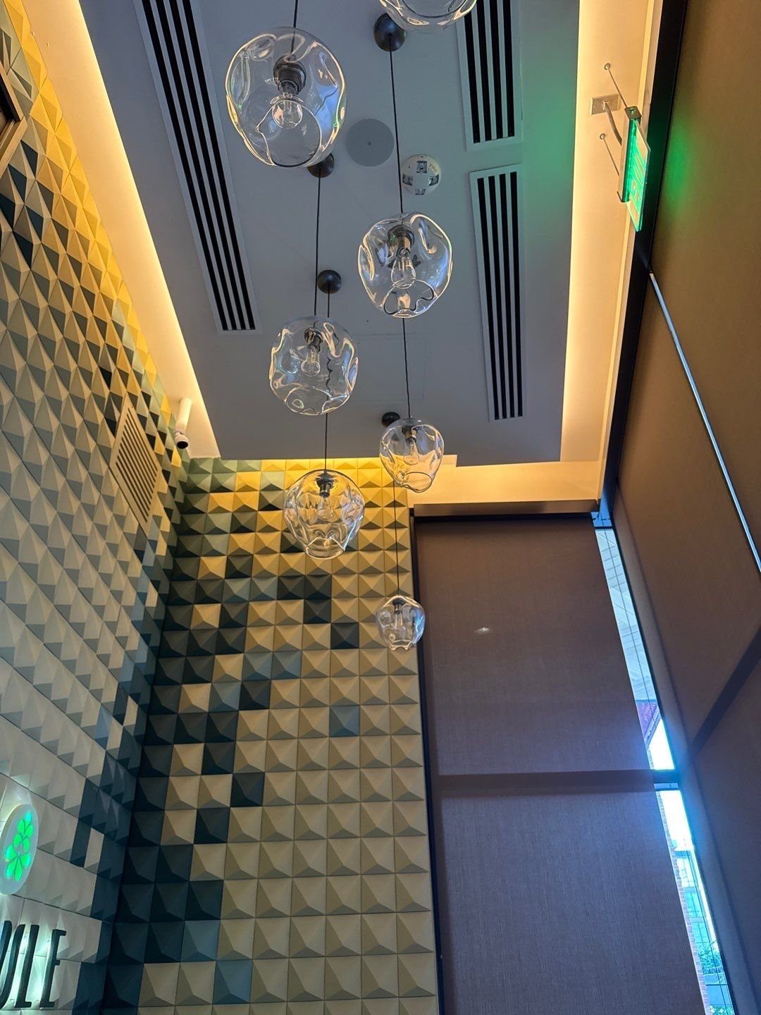 Painted ceiling soffit above the tile feature wall at the El Tule restaurant entry