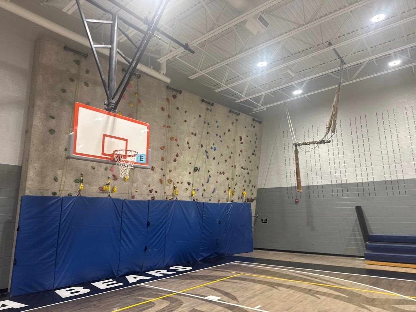 Two-tone painted gym wall beside the climbing wall at Mesa Middle School