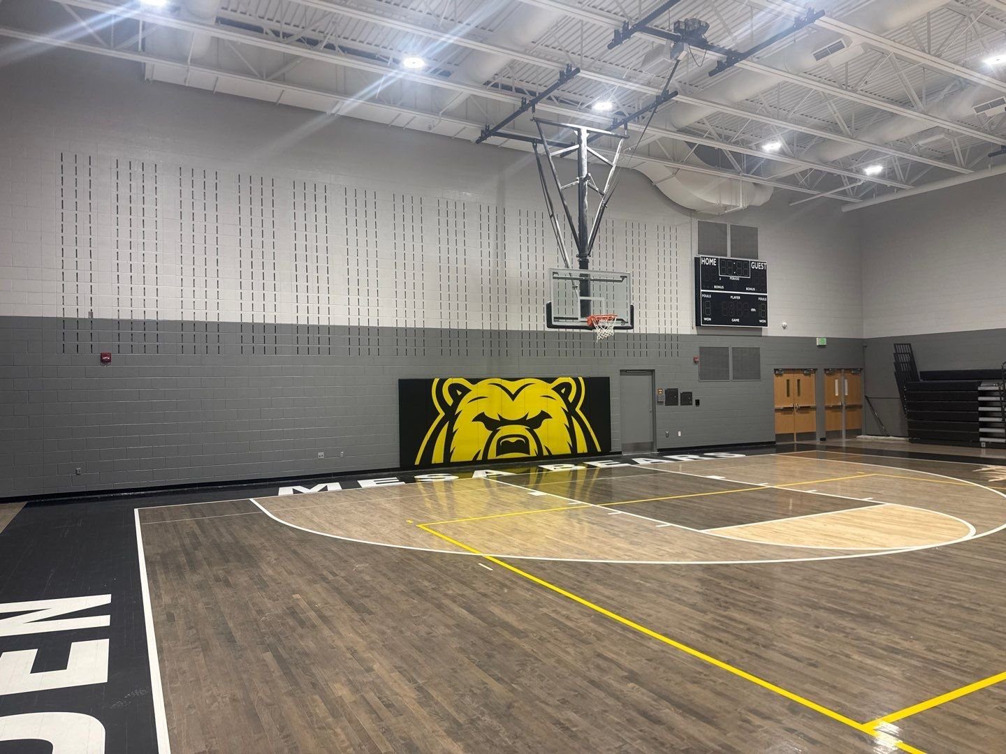 Finished Mesa Middle School gym wall with bear mascot pad and painted block walls